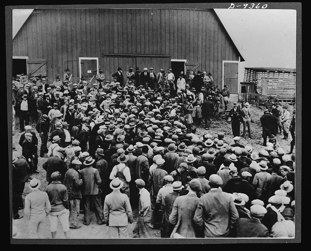 Large crowd of farmers and spectators gathered at a farm foreclosure auction in Iowa during the early 1930s