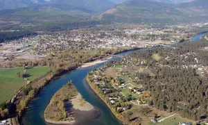 Aerial view of Libby, Montana nestled in the Kootenai River valley, surrounded by the Cabinet Mountains.