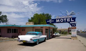 The Blue Swallow Motel on Route 66 in Tucumcari, New Mexico. A 1958 Buick sits in front of the iconic neon sign.