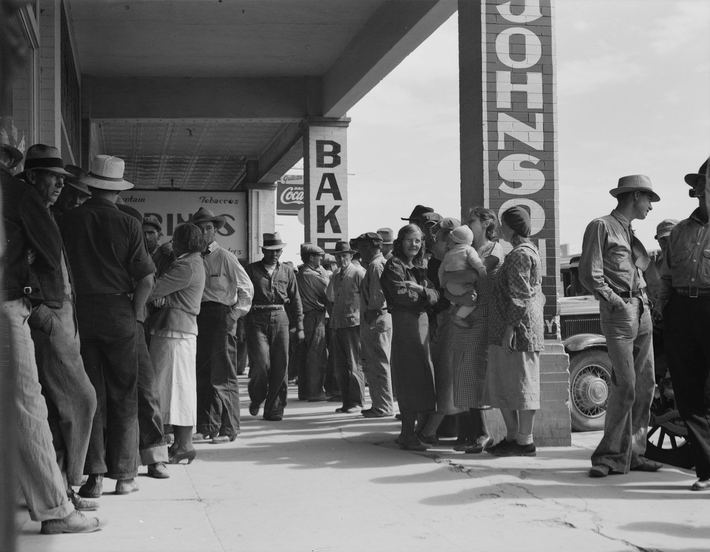 Americans waiting in line for relief checks during the Great Depression, Calipatria, California, 1937. Photograph by Dorothea Lange.